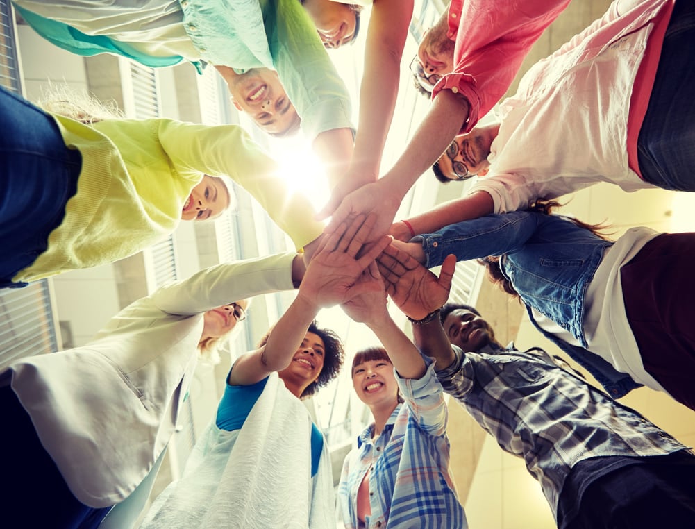 Group of International Students with Hands on Top of Each Other